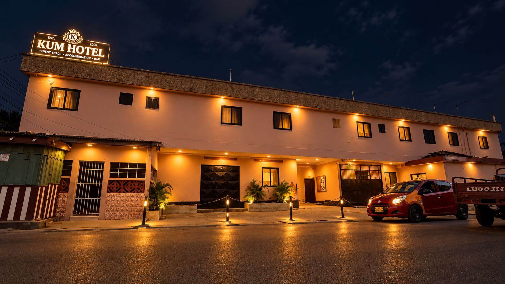 KUM Hotel exterior at night with the entrance lit up