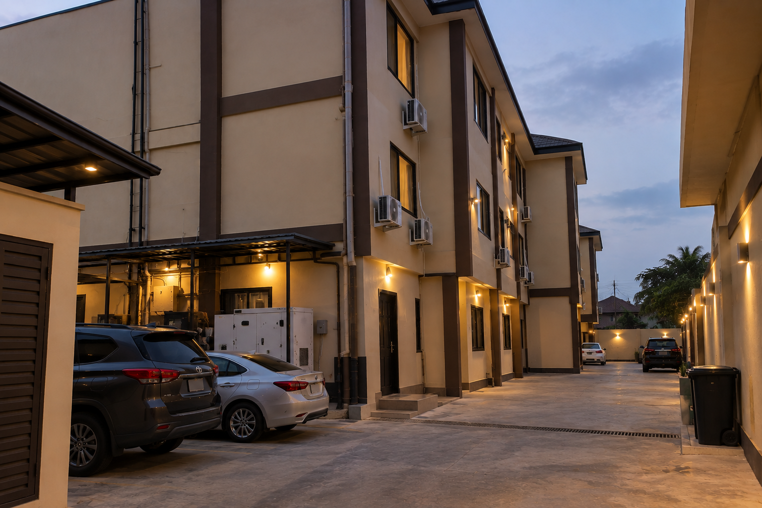 Side view of KUM Hotel at dusk showing guest room windows