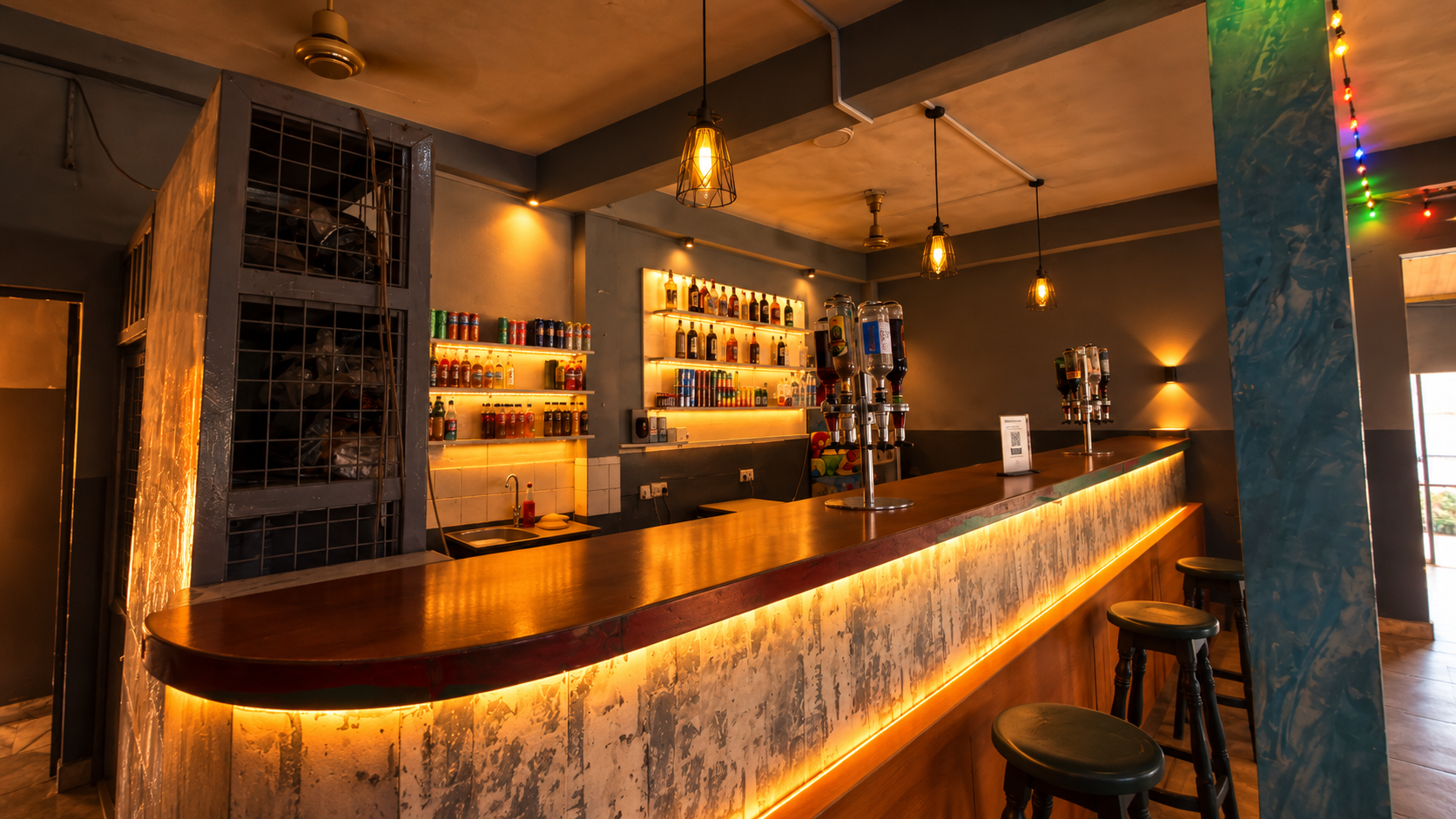 Side view of the KUM Hotel bar counter with warm pendant lighting